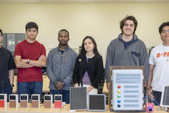 A group picture of students who worked during Summer of 2026 with their projects in front of them