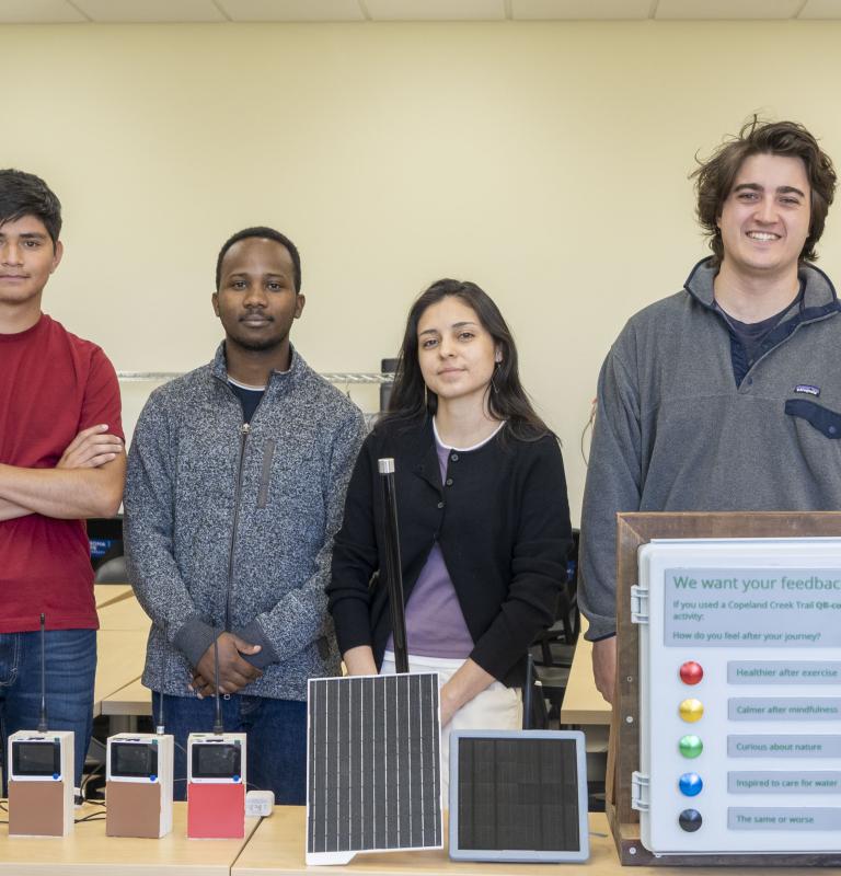 A group picture of students who worked during Summer of 2026 with their projects in front of them