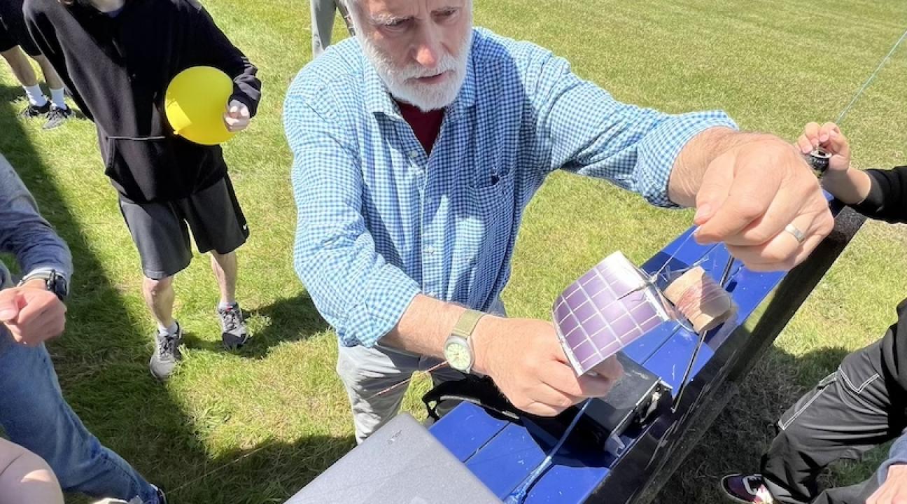 Picture of professor Rob Rowlands along with students preparing the balloon for launch