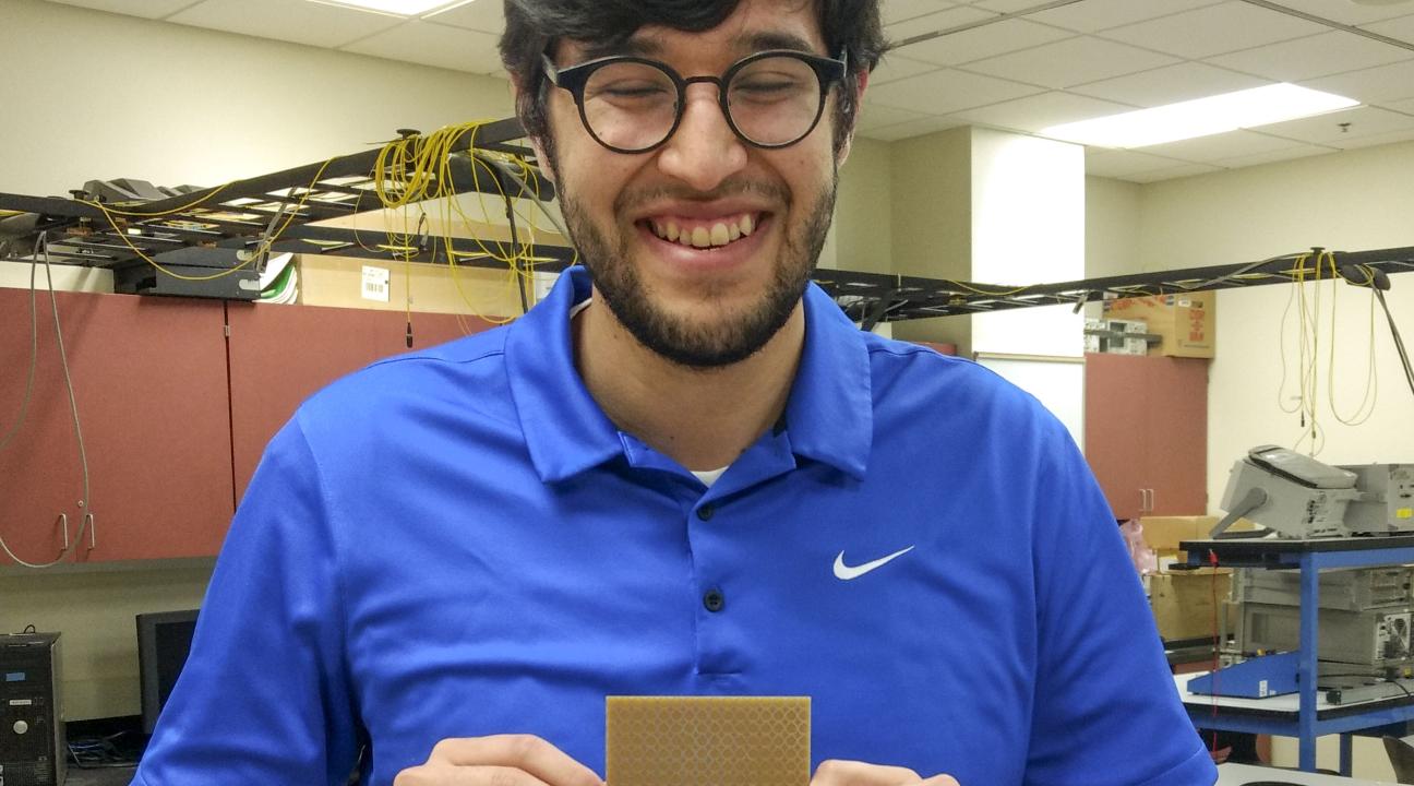 David House holding a prototype of the metasurface absorber