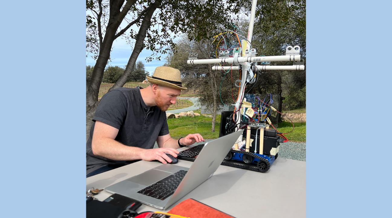 Scott Parmley is making some last minute tweaks to the code in the field.