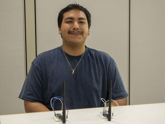 Picture of Eriberto Salgado with his project in front of him