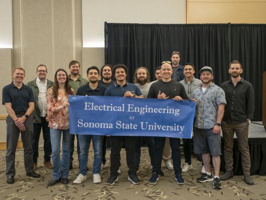 A group picture of Engineering alumni after the senior design expo