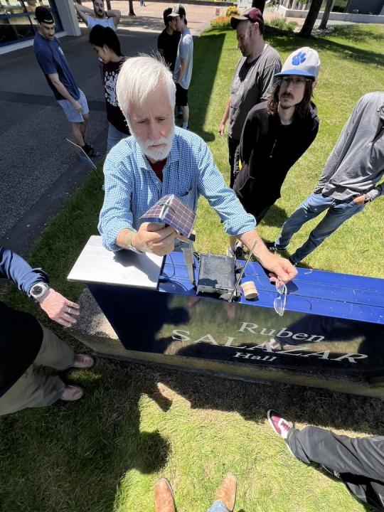 Picture of professor Rob Rowlands along with students preparing the balloon for launch