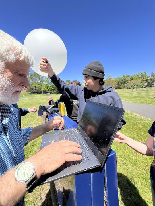 Picture of professor Rob Rowlands along with students preparing the balloon for launch